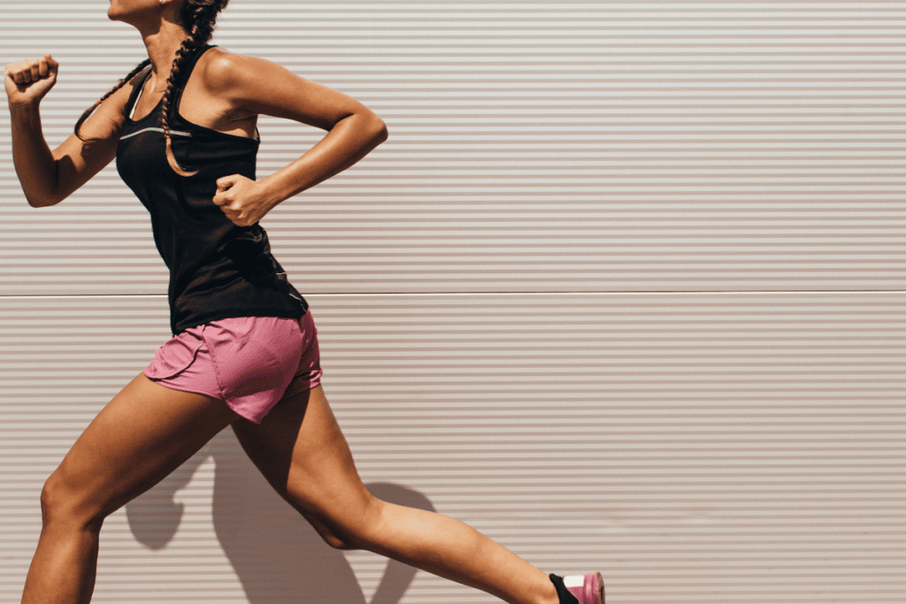 women running in pink split shorts