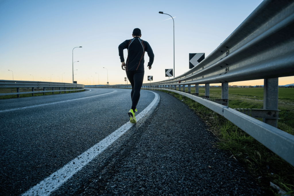 Man running on a highway